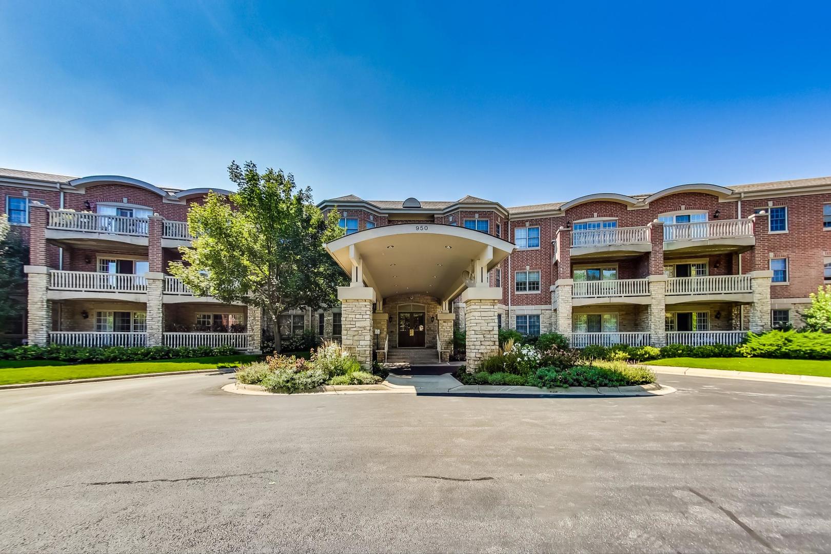 a front view of a building with a garden and plants