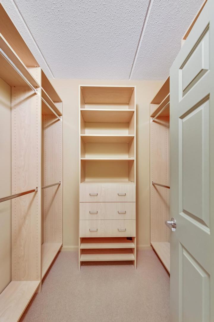 950 Augusta Way, Unit 204 Highland Park, IL 60035 - Photo 16 of 36 a view of walk in closet with empty racks