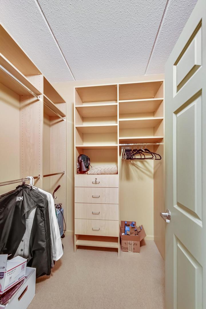 950 Augusta Way, Unit 204 Highland Park, IL 60035 - Photo 17 of 36 a view of walk in closet with clothes and shoes