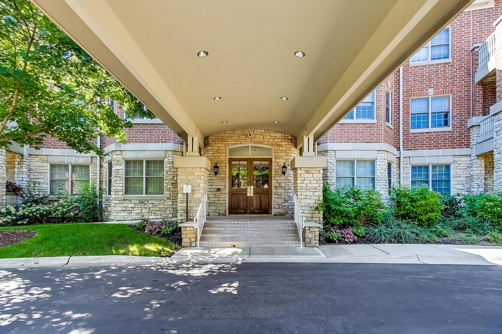 950 Augusta Way, Unit 204 Highland Park, IL 60035 - Photo 2 of 36 a front view of a building with a garden and plants