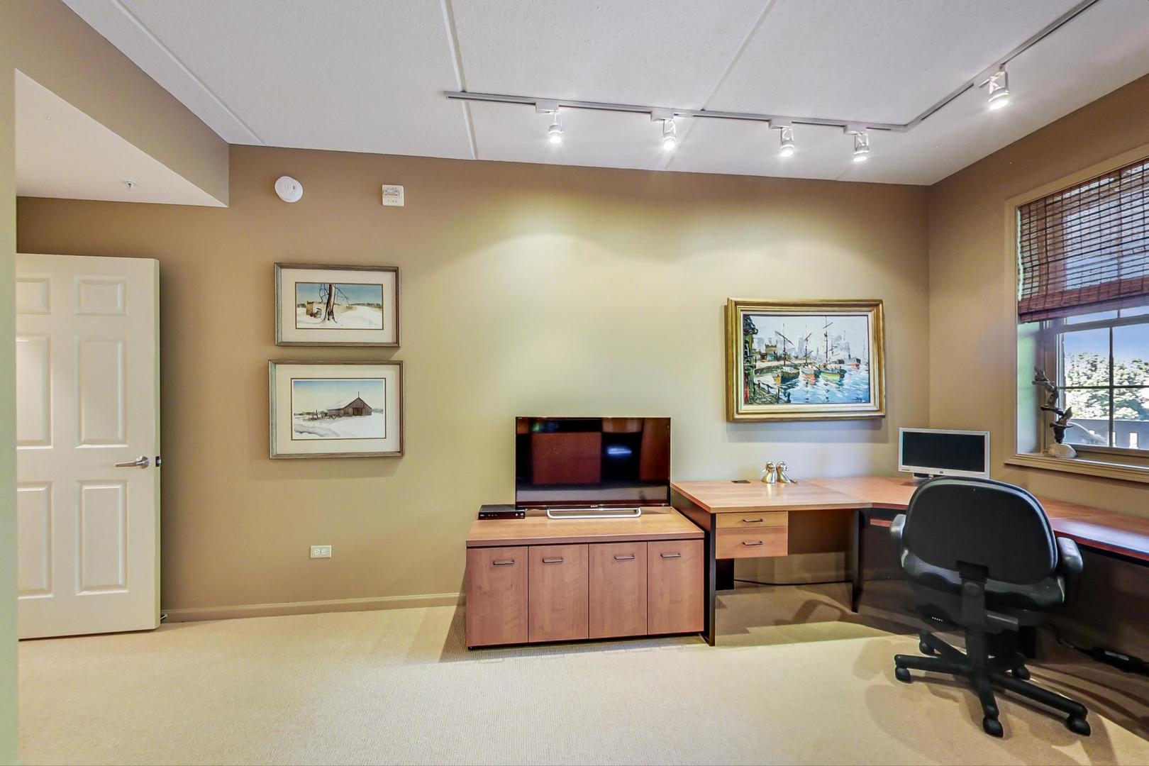 950 Augusta Way, Unit 204 Highland Park, IL 60035 - Photo 21 of 36 a living room with furniture and a flat screen tv