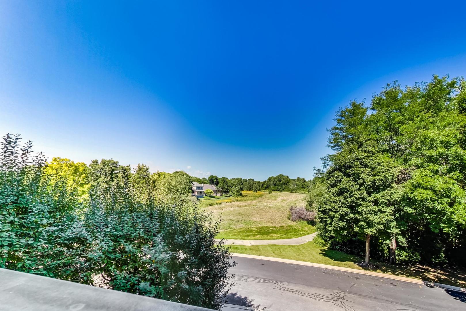 950 Augusta Way, Unit 204 Highland Park, IL 60035 - Photo 25 of 36 a view of a lake and a yard