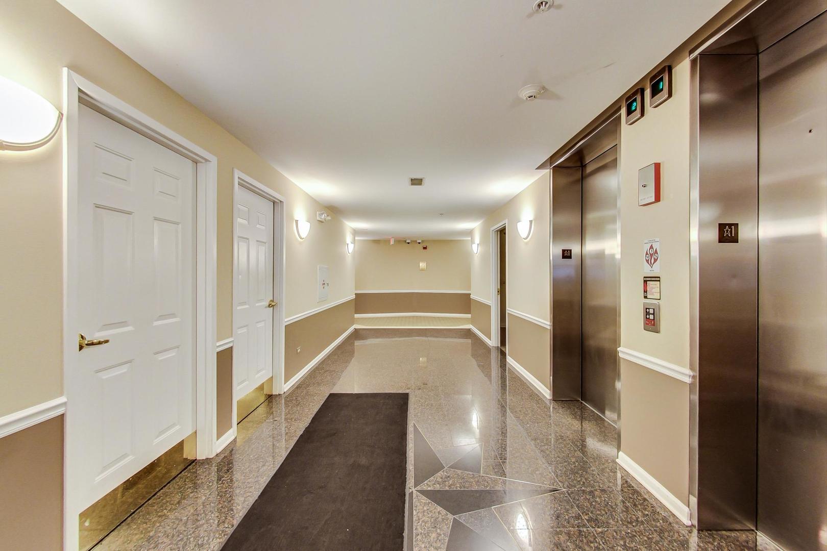 950 Augusta Way, Unit 204 Highland Park, IL 60035 - Photo 3 of 36 a bathroom with a glass shower door and a glass door shower