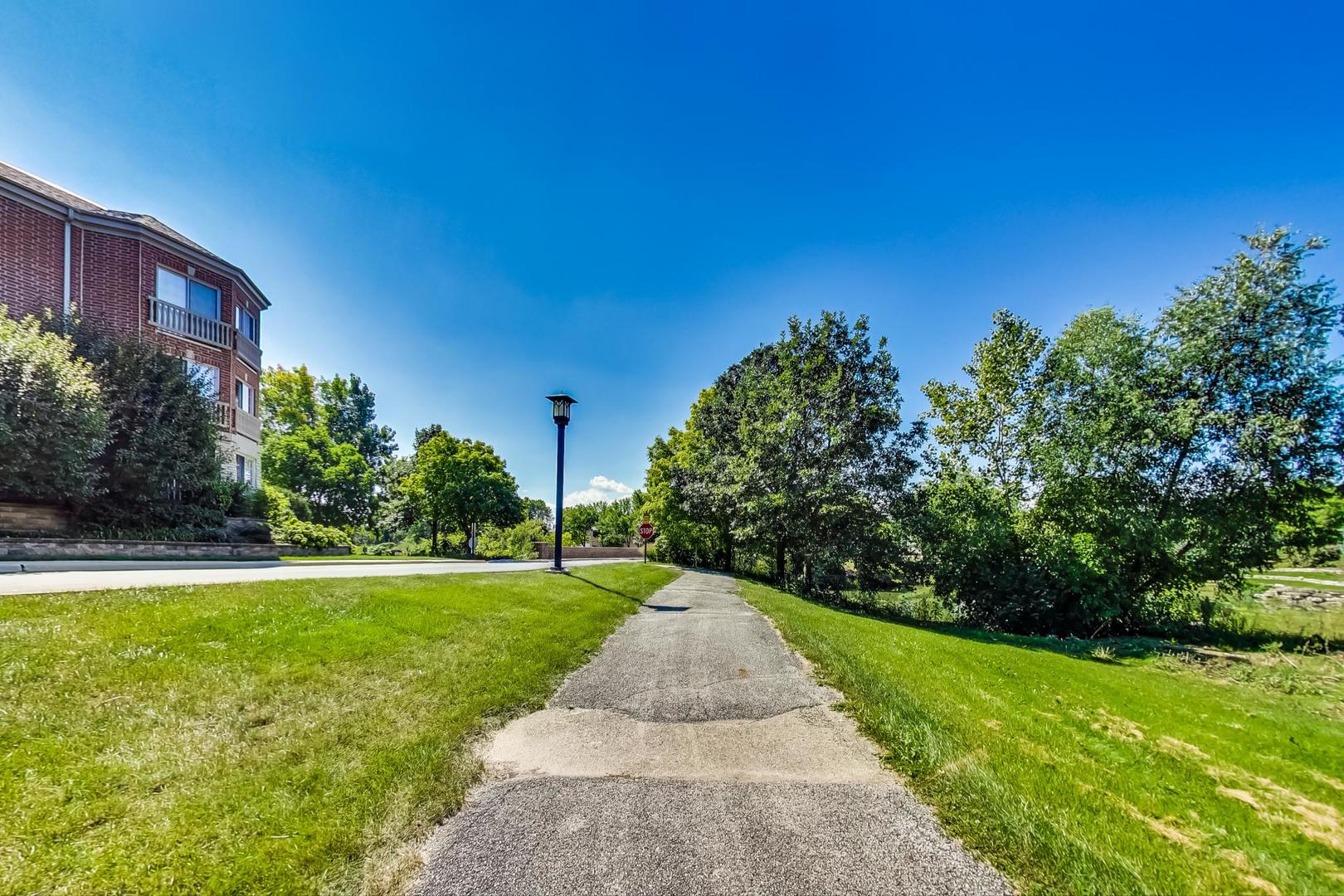 950 Augusta Way, Unit 204 Highland Park, IL 60035 - Photo 32 of 36 a view of a garden with a building in the background