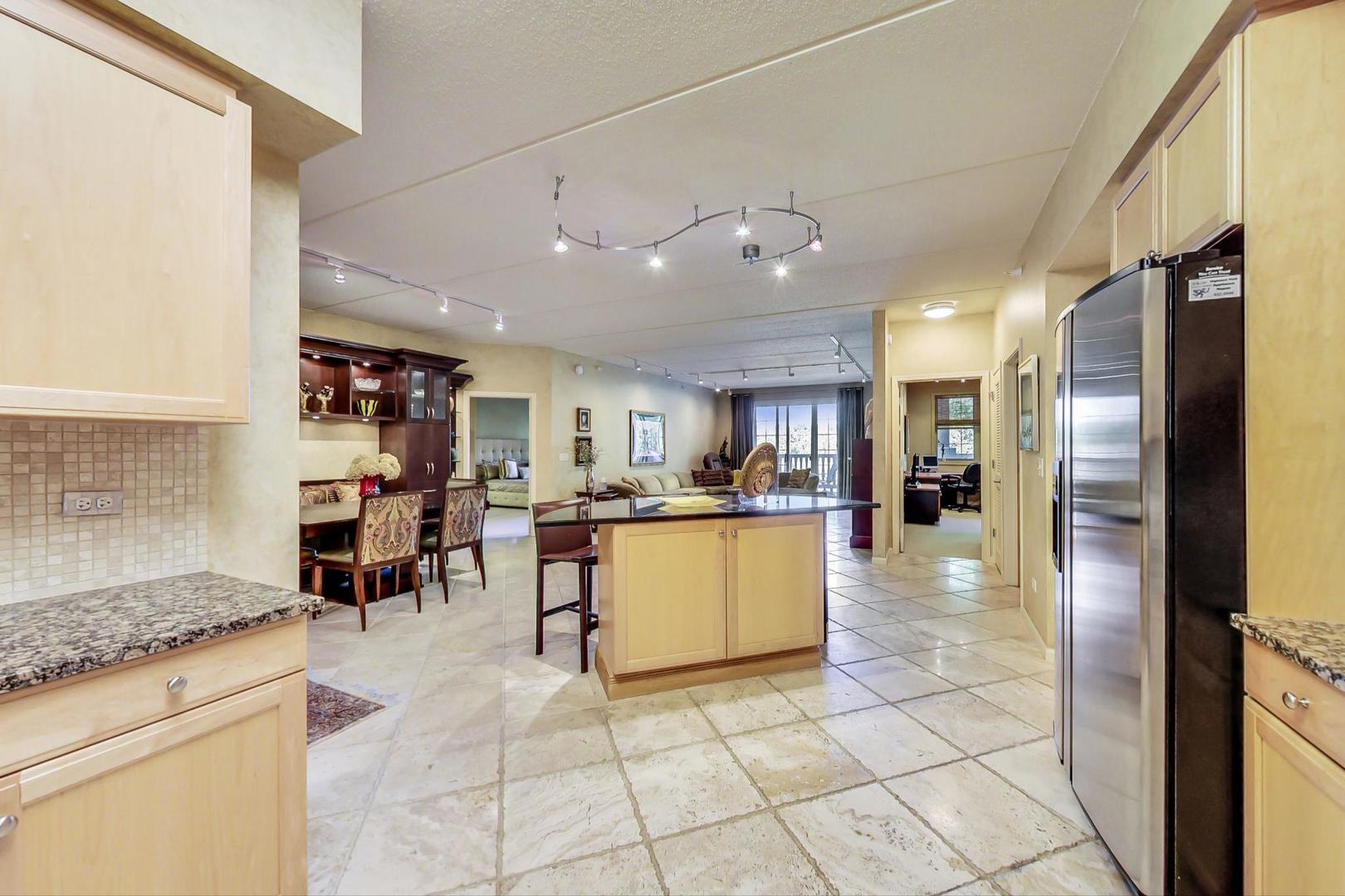 950 Augusta Way, Unit 204 Highland Park, IL 60035 - Photo 6 of 36 a large kitchen with a dining table and chairs