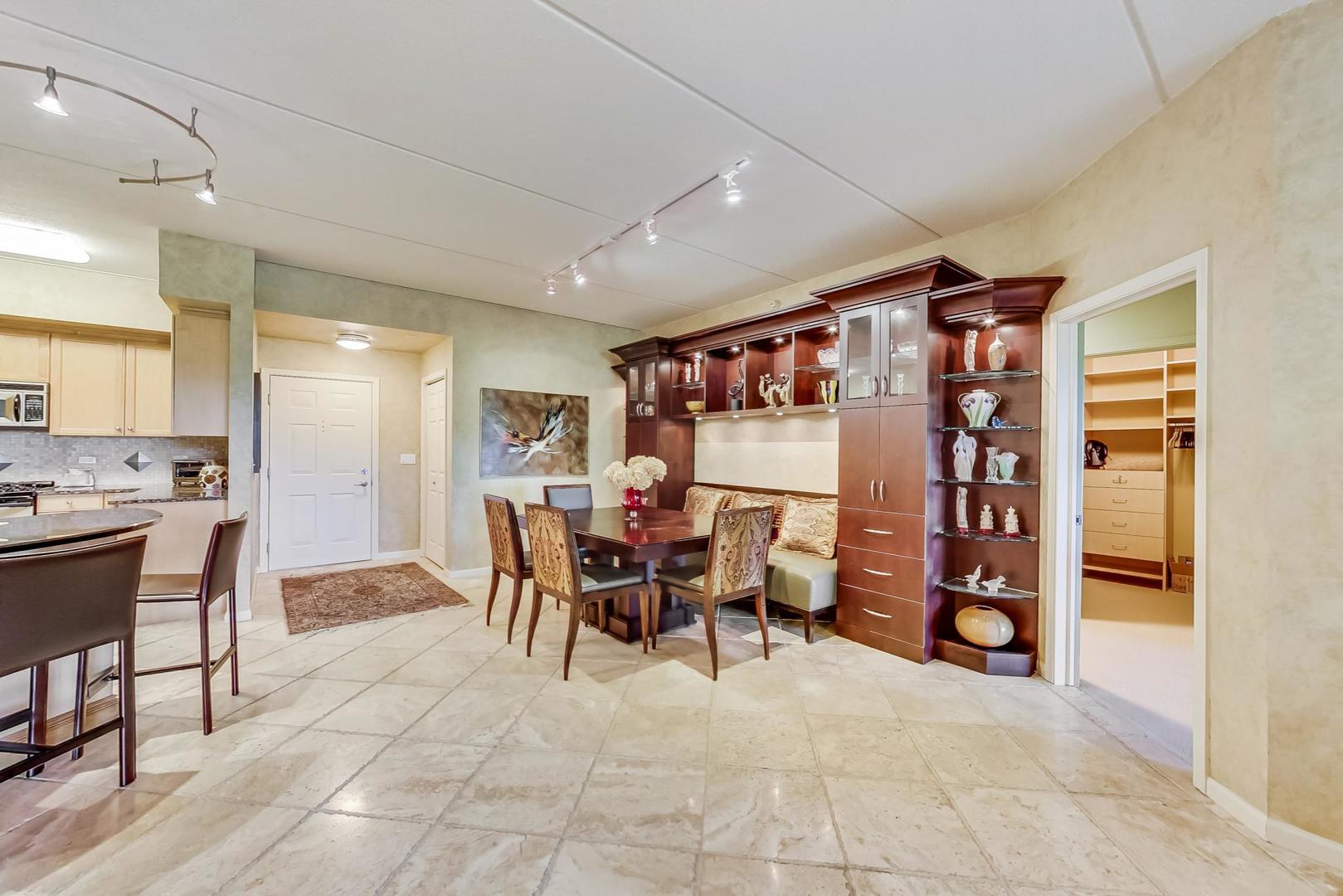 950 Augusta Way, Unit 204 Highland Park, IL 60035 - Photo 8 of 36 a dining hall with stainless steel appliances granite countertop a table and chairs