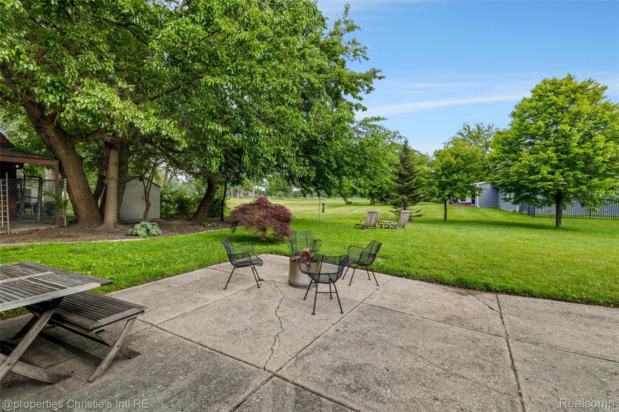 2771 West Seven Mile Road Detroit, MI 48221 - Photo 48 of 57 Expansive concrete patio with a central fire pit area
