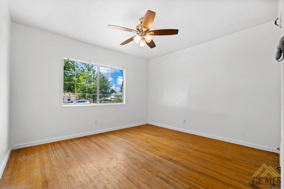 Undisclosed Address Bakersfield, CA 93308 - Photo 12 of 24 wooden floor in an empty room with a window