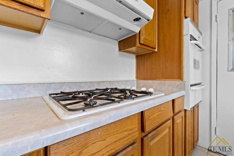 Undisclosed Address Bakersfield, CA 93308 - Photo 15 of 24 a kitchen with stainless steel appliances granite countertop a stove and a microwave