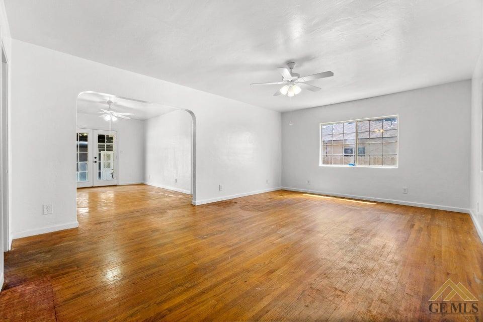Undisclosed Address Bakersfield, CA 93308 - Photo 22 of 24 a view of an empty room with window and wooden floor