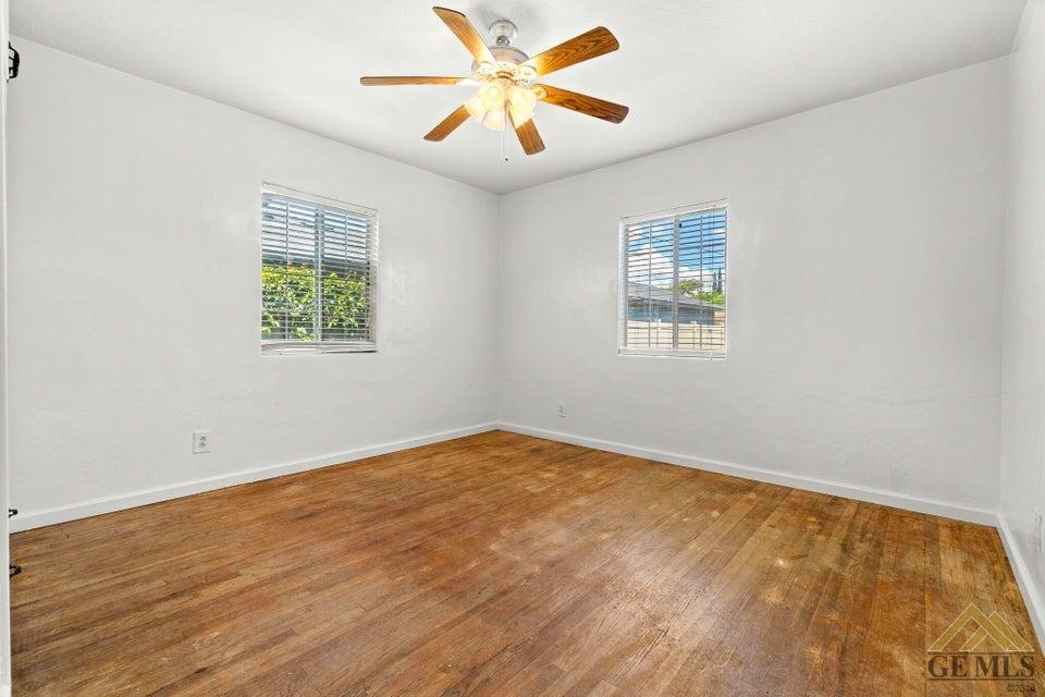 Undisclosed Address Bakersfield, CA 93308 - Photo 9 of 24 an empty room with windows and fan