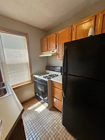 a kitchen with a refrigerator stove and a sink