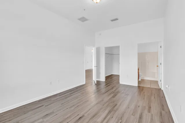 a view of an empty room and wooden floor