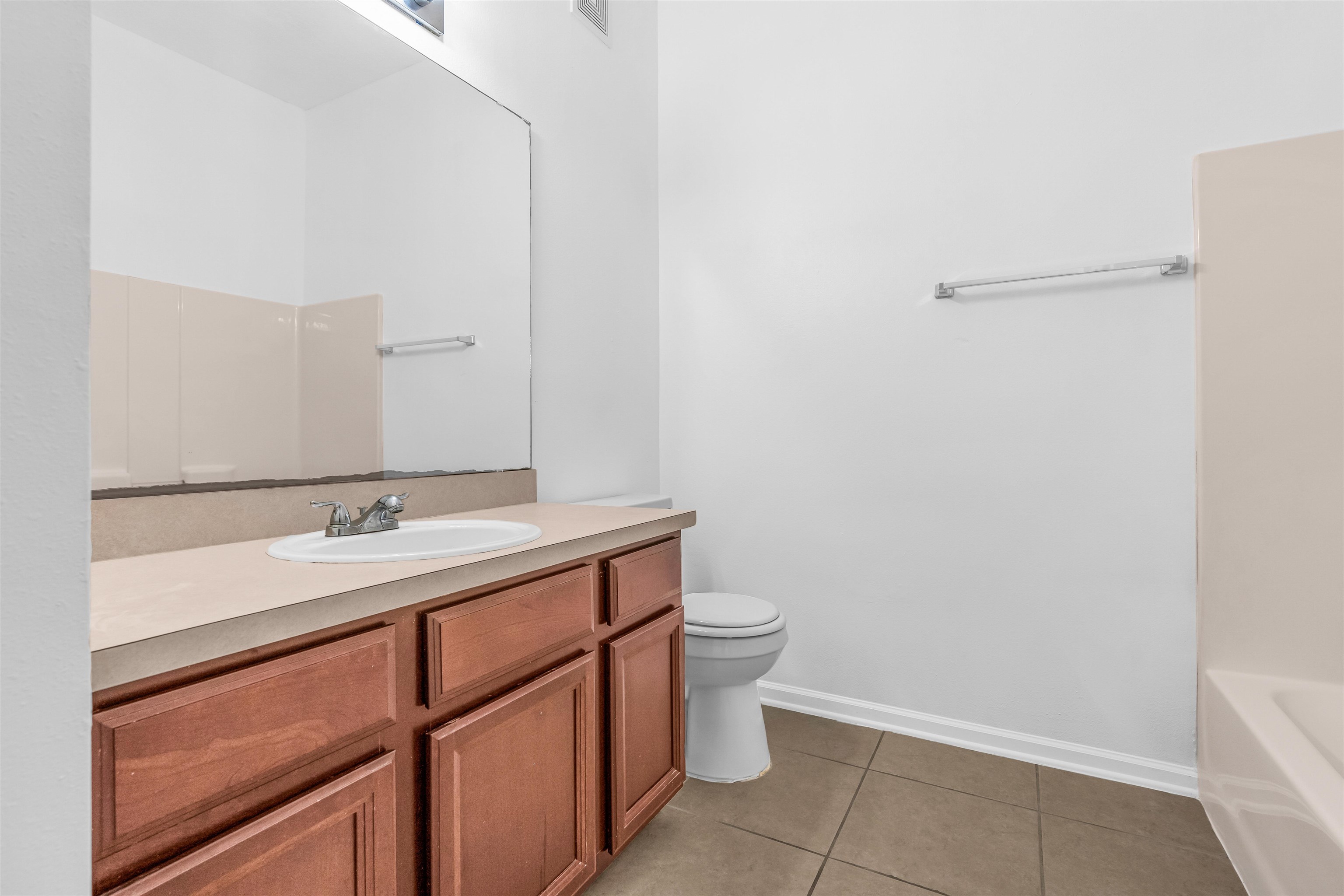 406 Golden Lake Loop St. Augustine, FL 32084 - Photo 17 of 51 a bathroom with a sink a toilet and a mirror