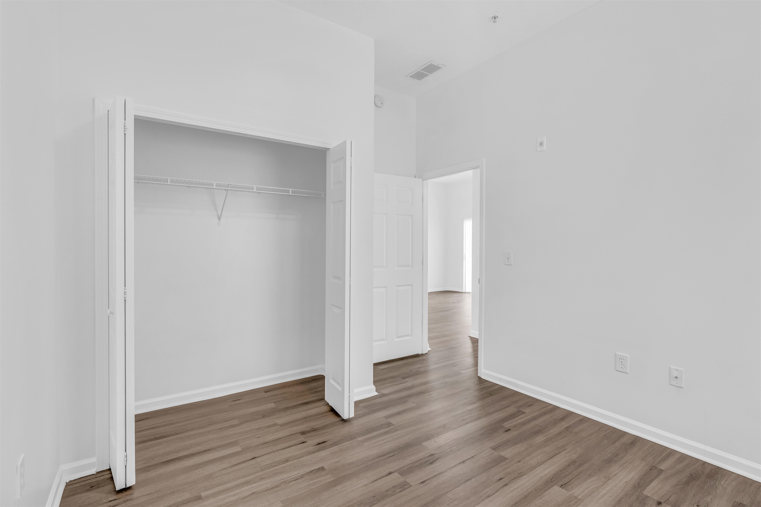 406 Golden Lake Loop St. Augustine, FL 32084 - Photo 19 of 51 a view of an empty room with wooden floor