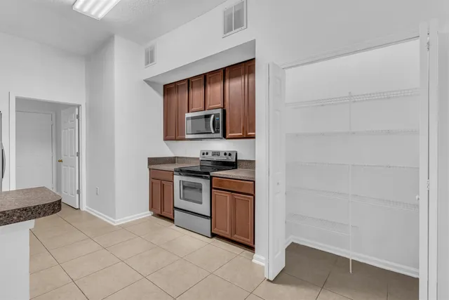 a kitchen with a stove and a refrigerator