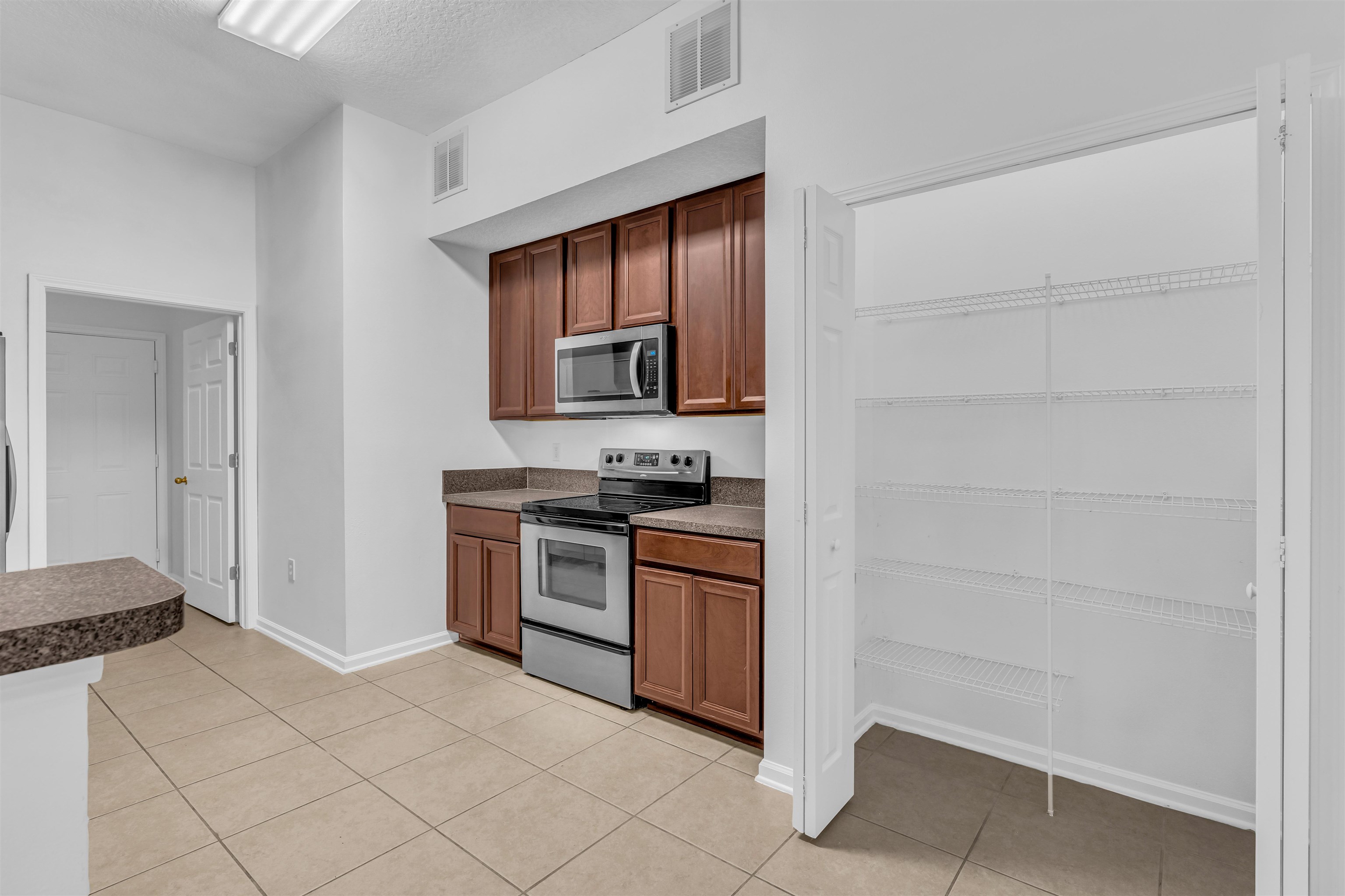 406 Golden Lake Loop St. Augustine, FL 32084 - Photo 2 of 51 a kitchen with a stove and a refrigerator