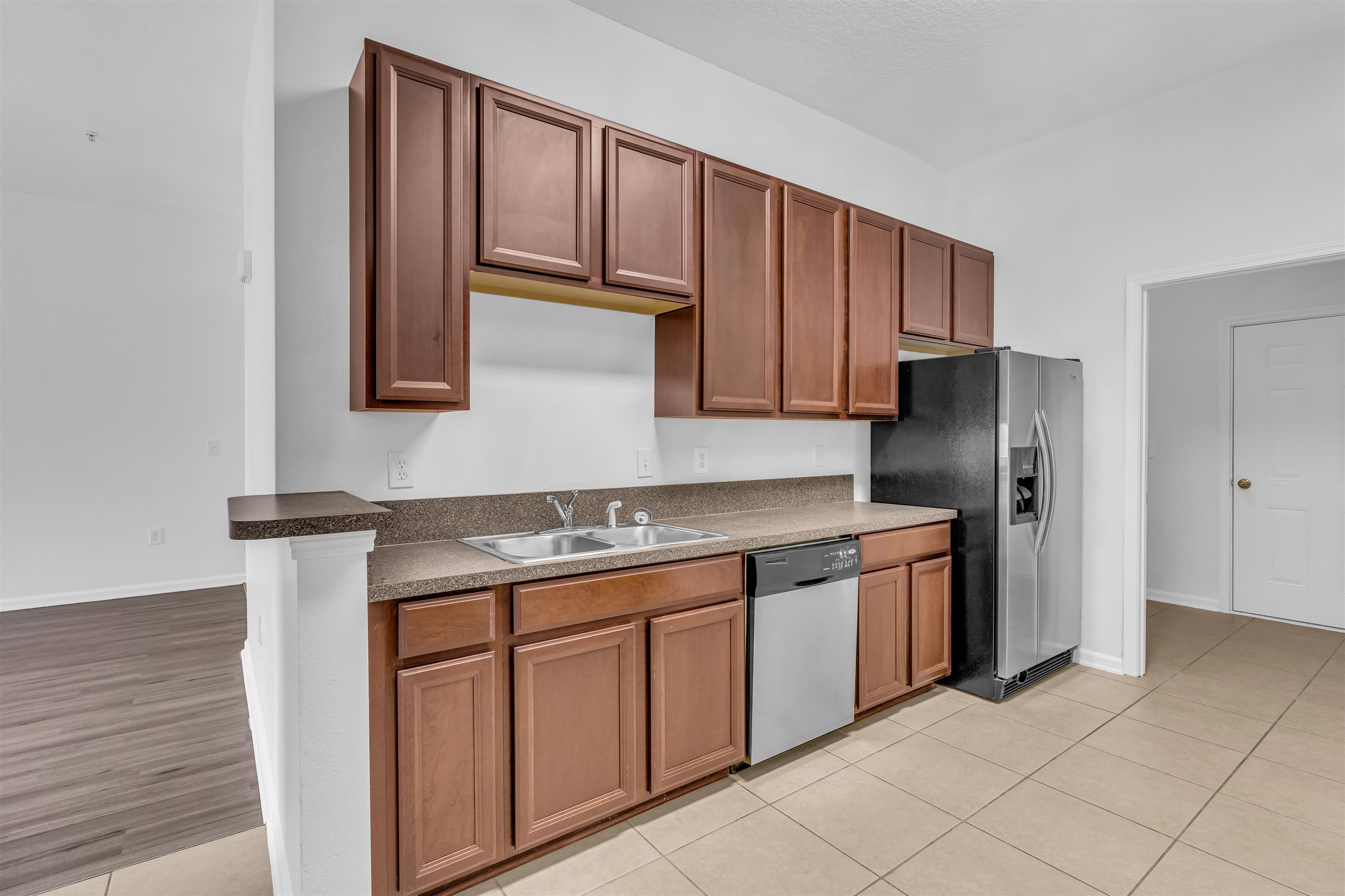 406 Golden Lake Loop St. Augustine, FL 32084 - Photo 3 of 51 a kitchen with stainless steel appliances granite countertop a stove a sink and a refrigerator with wooden cabinets