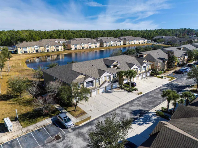 an aerial view of residential house with outdoor space and lake view
