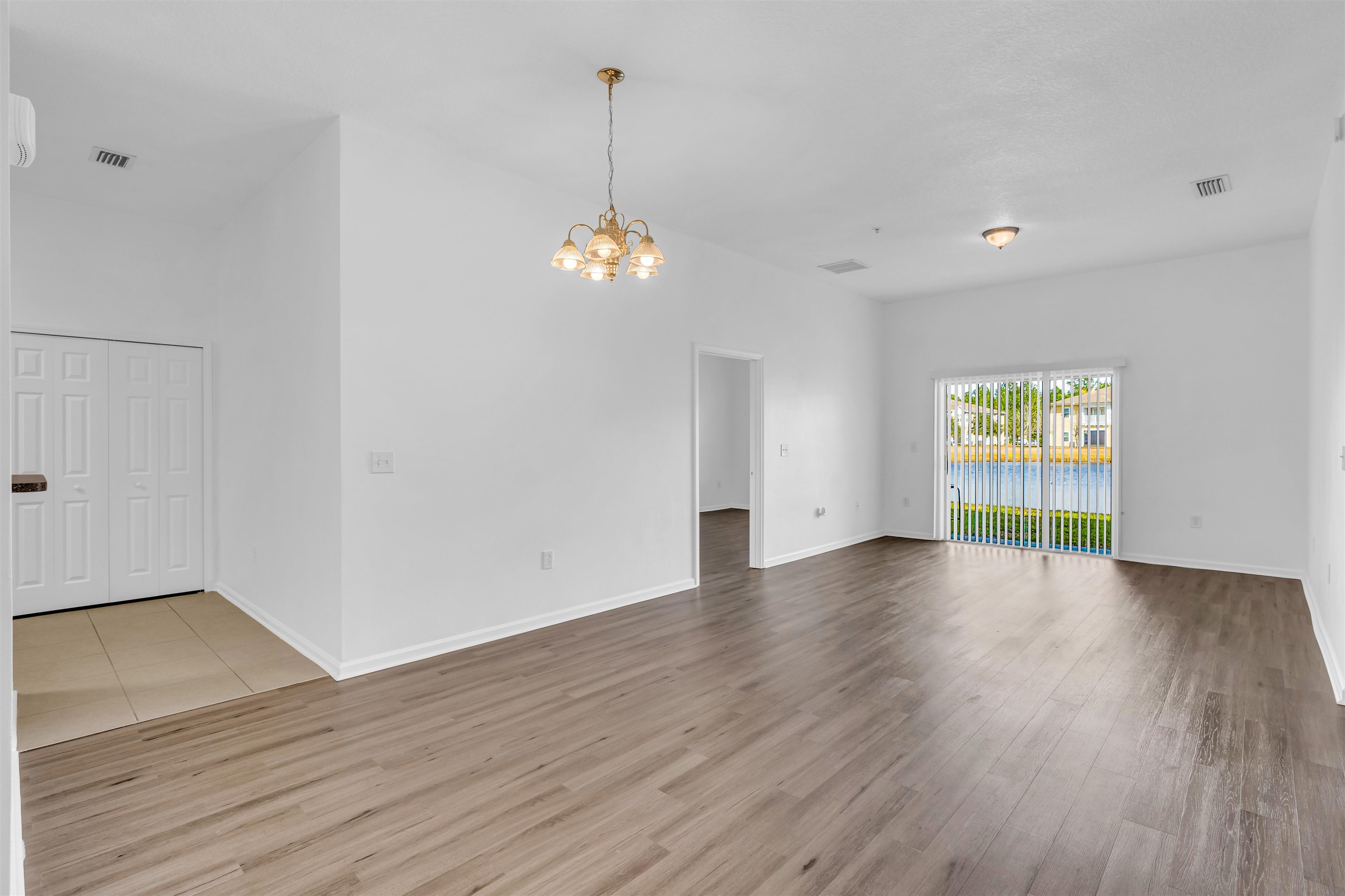 406 Golden Lake Loop St. Augustine, FL 32084 - Photo 7 of 51 a view of an empty room with wooden floor and a window