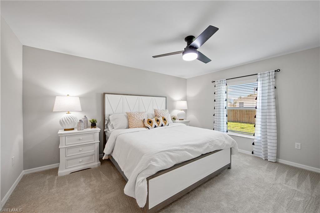 4139 Tulia Way North Fort Myers, FL 33917 - Photo 19 of 32 a bedroom with a bed and a window