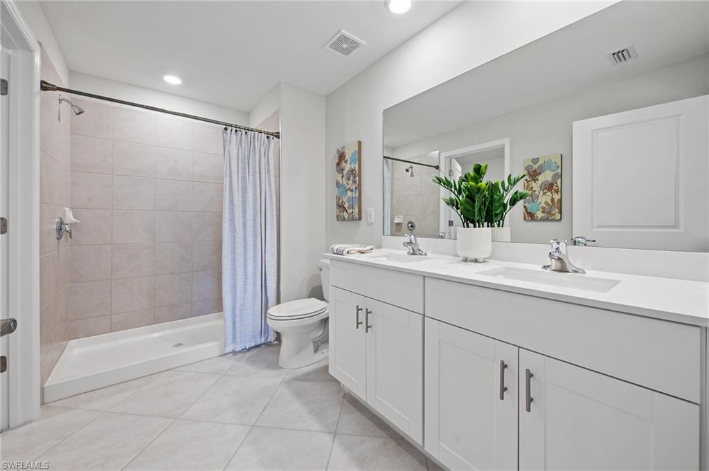 4139 Tulia Way North Fort Myers, FL 33917 - Photo 20 of 32 a bathroom with a sink toilet and shower