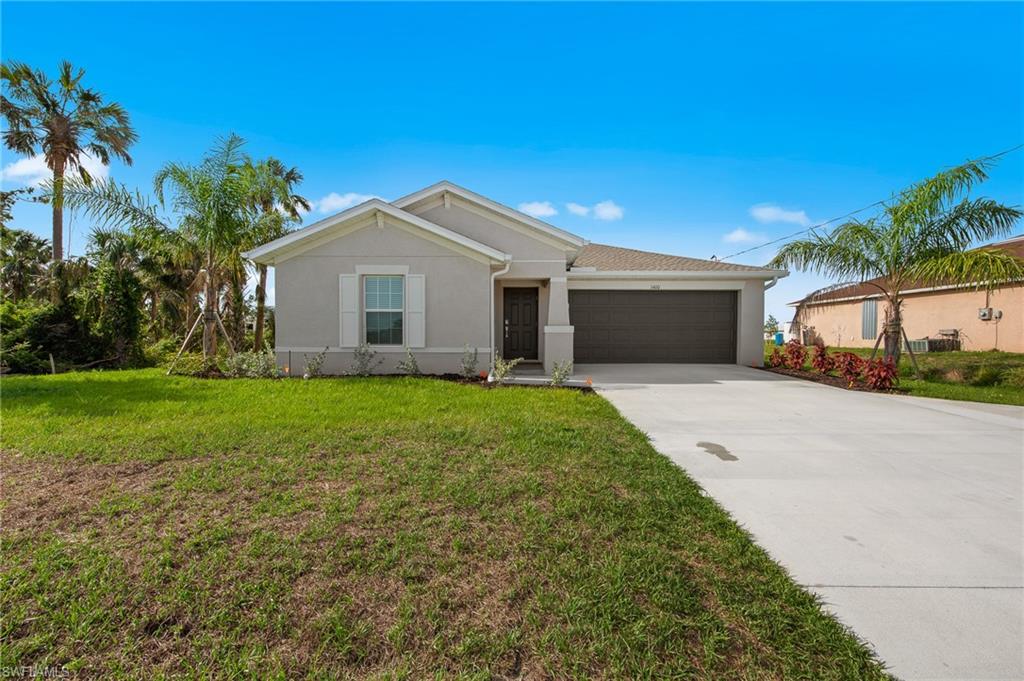 4139 Tulia Way North Fort Myers, FL 33917 - Photo 31 of 32 a front view of house with yard and green space