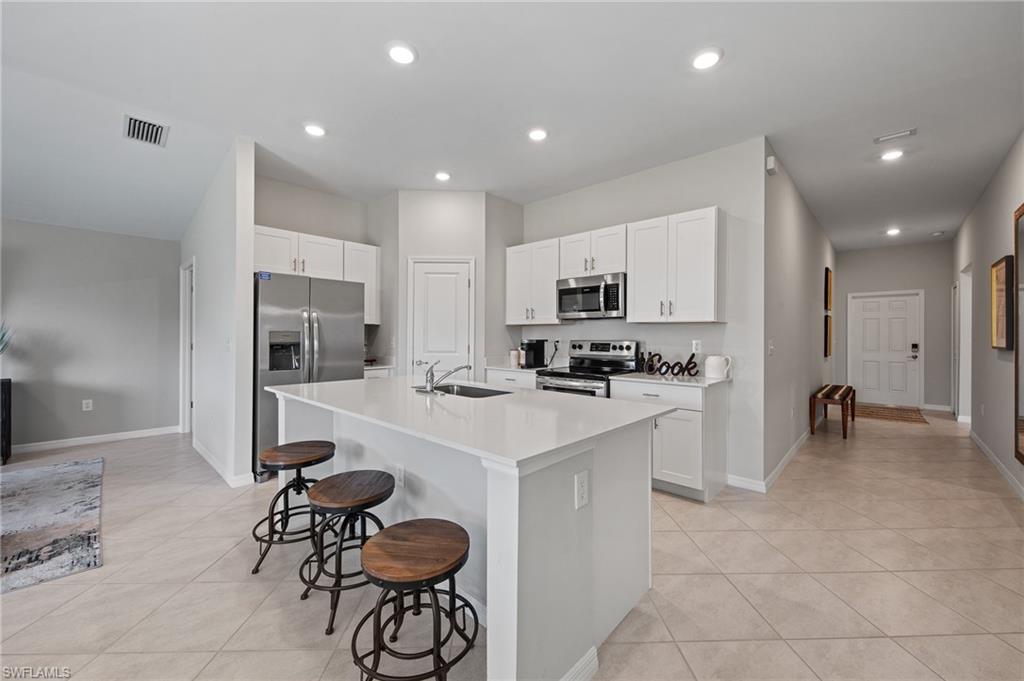 4139 Tulia Way North Fort Myers, FL 33917 - Photo 6 of 32 a kitchen with a sink a counter space appliances and cabinets