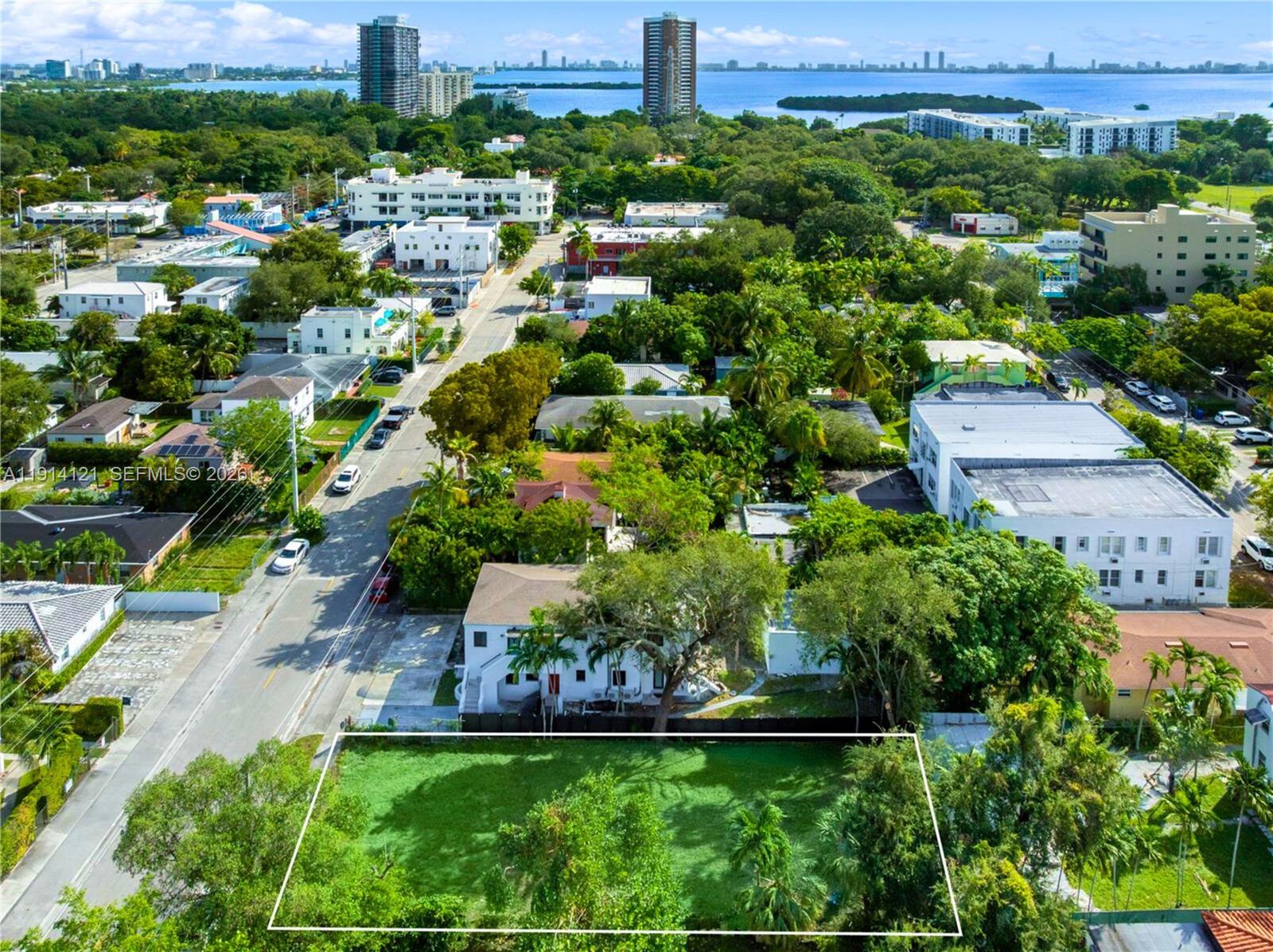 an aerial view of a house with a yard and lake view