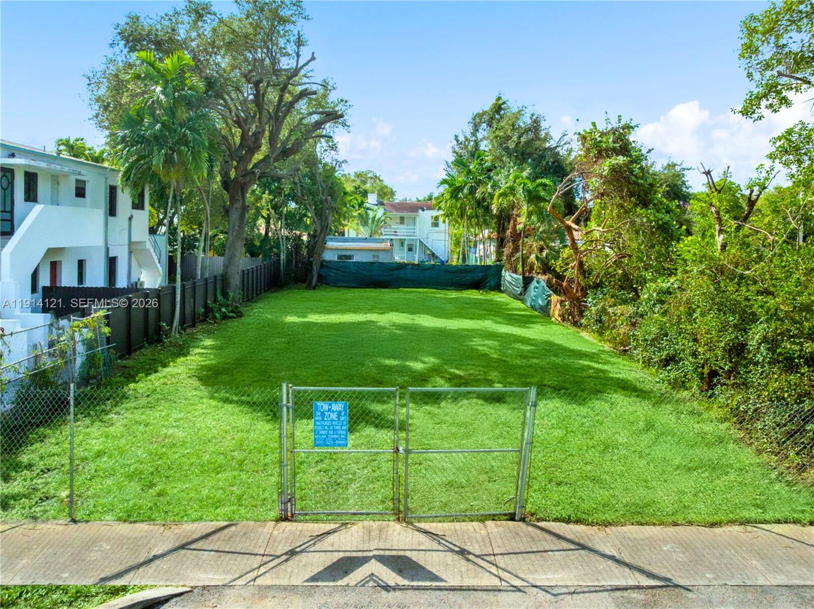 508 Northeast 67th Street Miami, FL 33138 - Photo 10 of 27 a backyard of a house with plants and large trees
