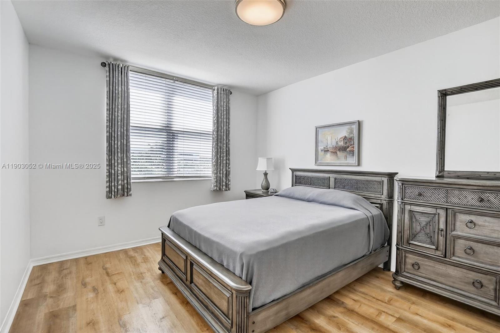 2421 Northeast 65th Street, Unit 508 Fort Lauderdale, FL 33308 - Photo 12 of 29 a bedroom with a bed and window