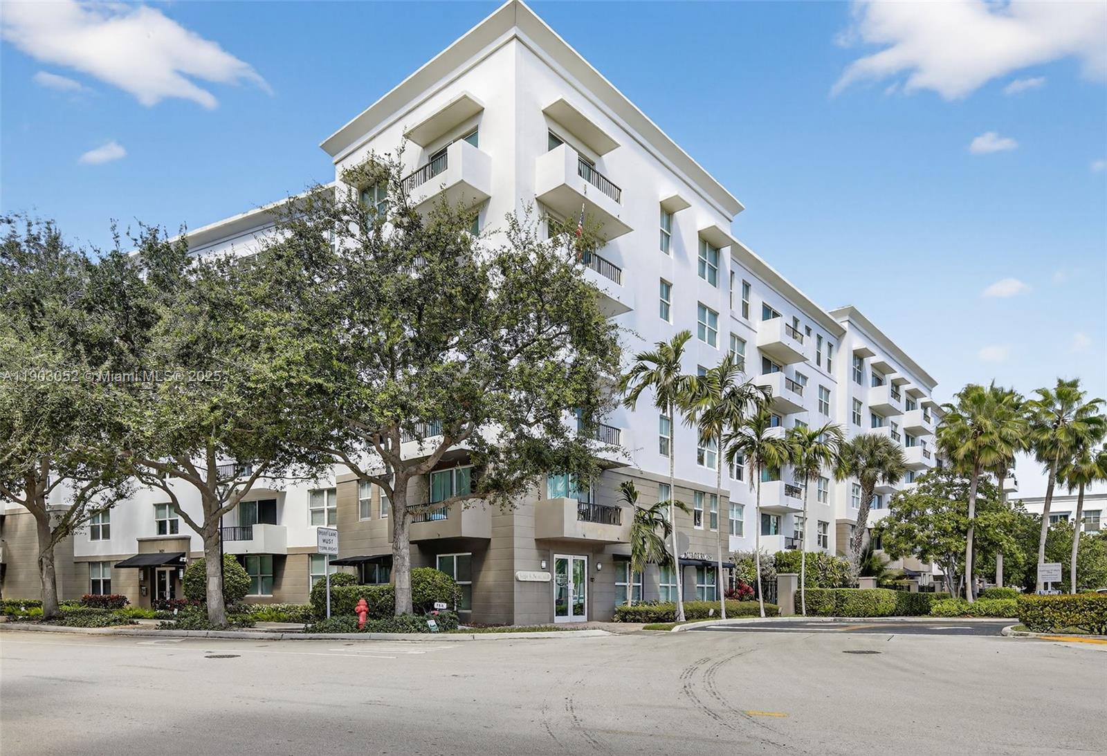 2421 Northeast 65th Street, Unit 508 Fort Lauderdale, FL 33308 - Photo 2 of 29 a city street lined with buildings and trees