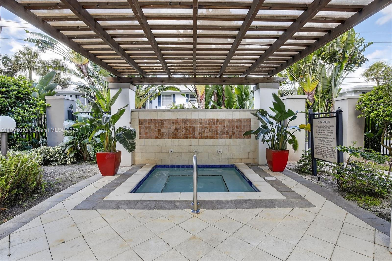 2421 Northeast 65th Street, Unit 508 Fort Lauderdale, FL 33308 - Photo 21 of 29 a view of yellow house with potted plants