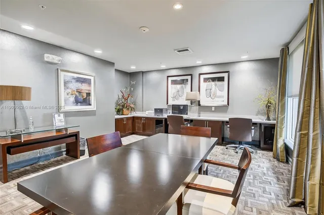 a living room with stainless steel appliances furniture and a flat screen tv