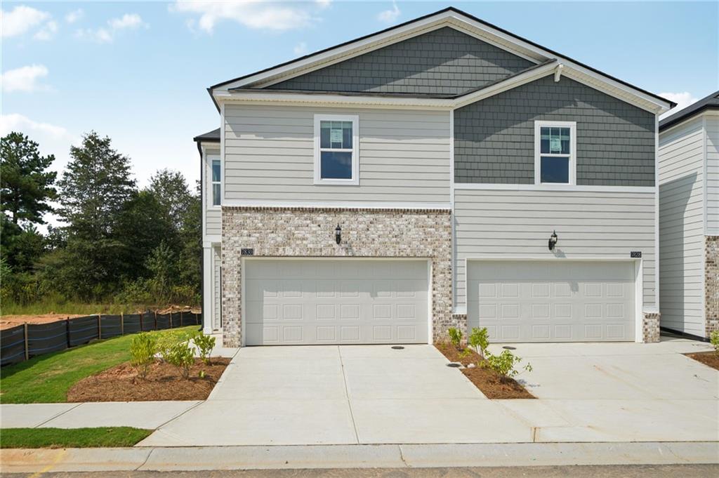 7830 Marie Way Fairburn, GA 30213 - Photo 1 of 30 a front view of a house with garden