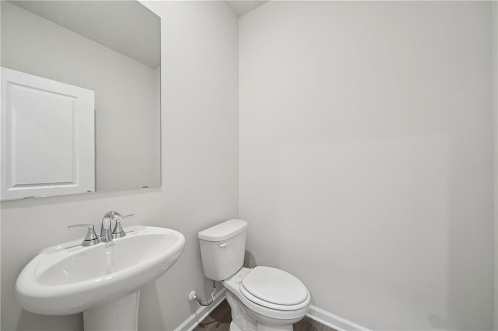 7830 Marie Way Fairburn, GA 30213 - Photo 14 of 30 a bathroom with a sink a toilet and mirror