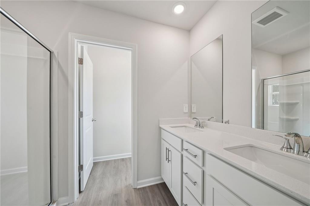 7830 Marie Way Fairburn, GA 30213 - Photo 20 of 30 a bathroom with double sink and a mirror