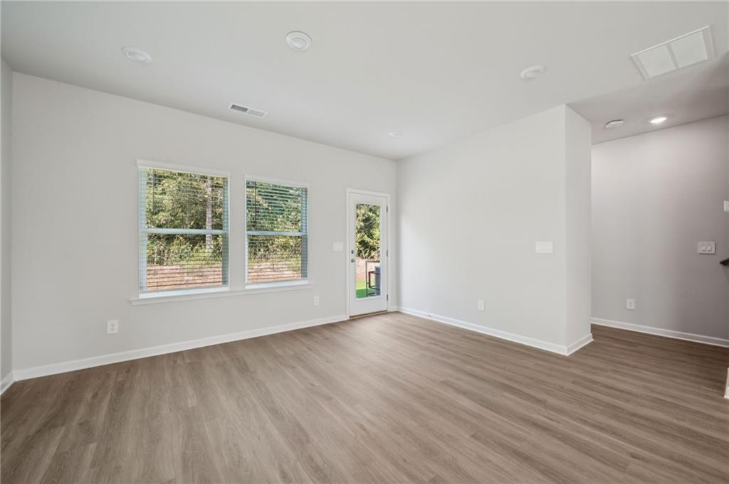 7830 Marie Way Fairburn, GA 30213 - Photo 4 of 30 an empty room with wooden floor and windows