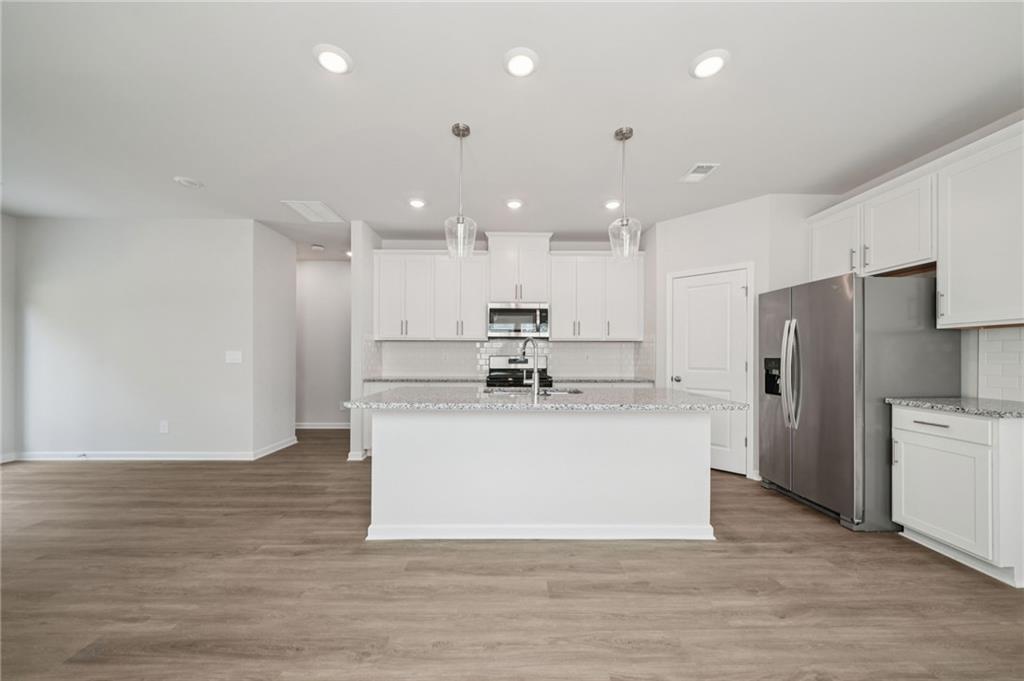 7830 Marie Way Fairburn, GA 30213 - Photo 8 of 30 a view of kitchen with stainless steel appliances kitchen island a stove a refrigerator a sink and a refrigerator