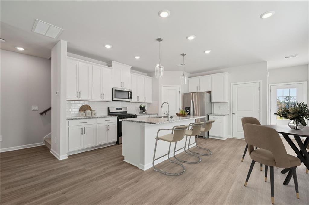 7830 Marie Way Fairburn, GA 30213 - Photo 10 of 30 a kitchen with a sink cabinets and wooden floor