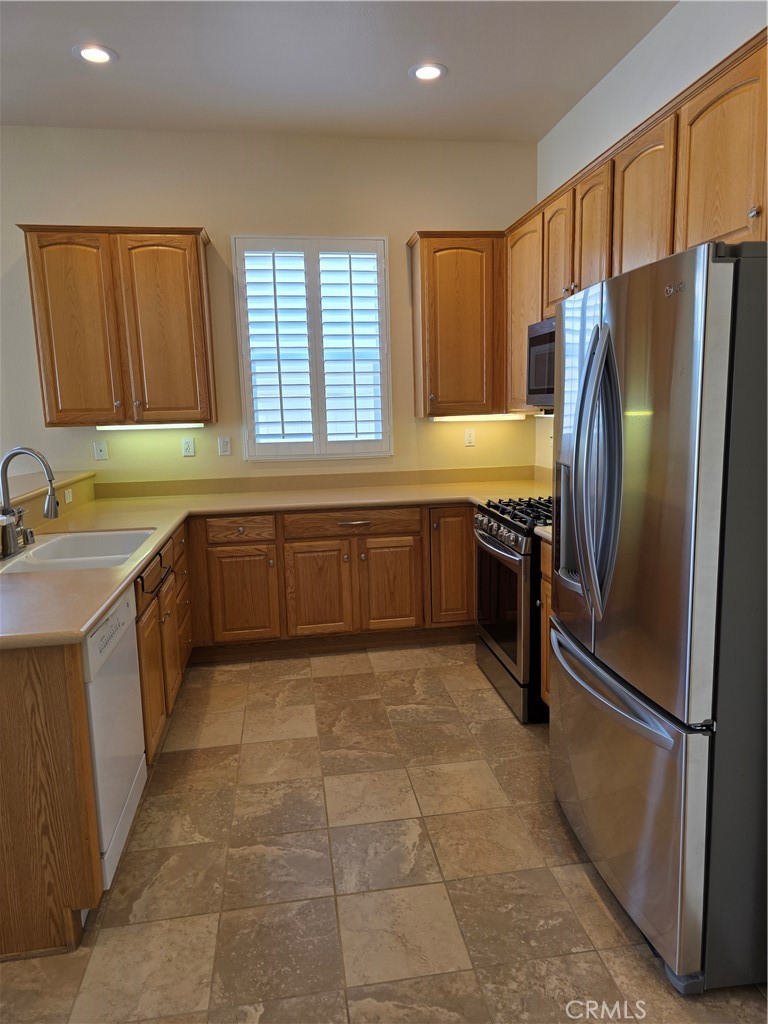 924 Brentwood Road Beaumont, CA 92223 - Photo 12 of 41 a kitchen with stainless steel appliances granite countertop a refrigerator and a sink
