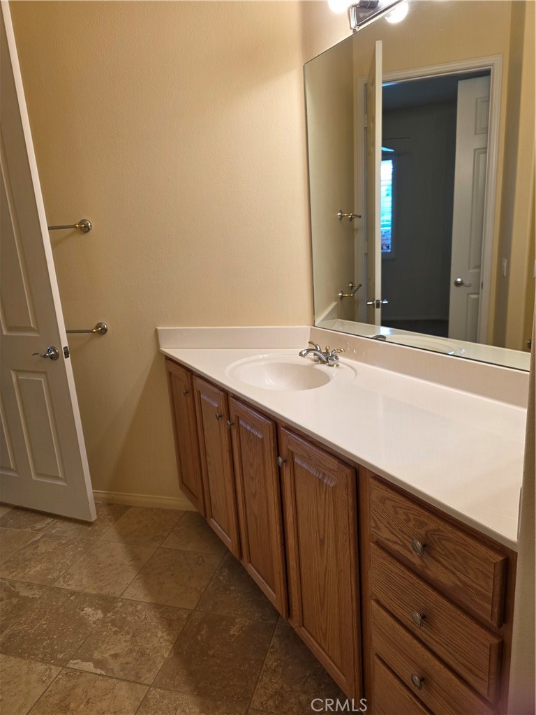 924 Brentwood Road Beaumont, CA 92223 - Photo 17 of 41 a bathroom with a sink a mirror and a vanity