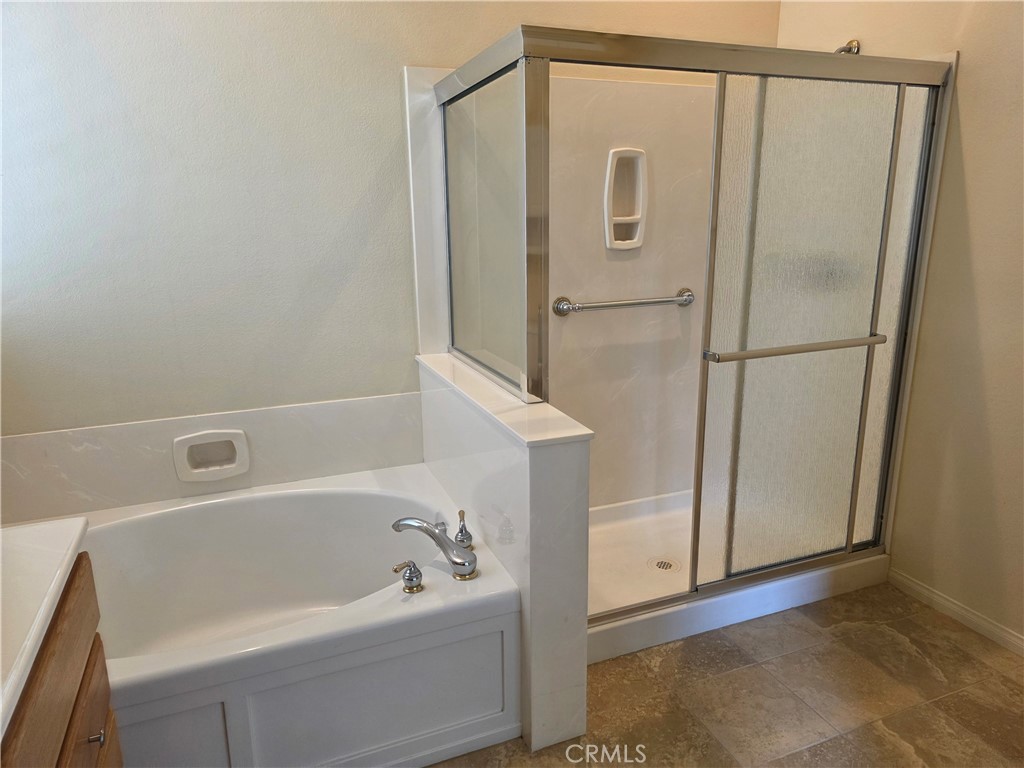 924 Brentwood Road Beaumont, CA 92223 - Photo 28 of 41 a bathroom with a bathtub and a shower