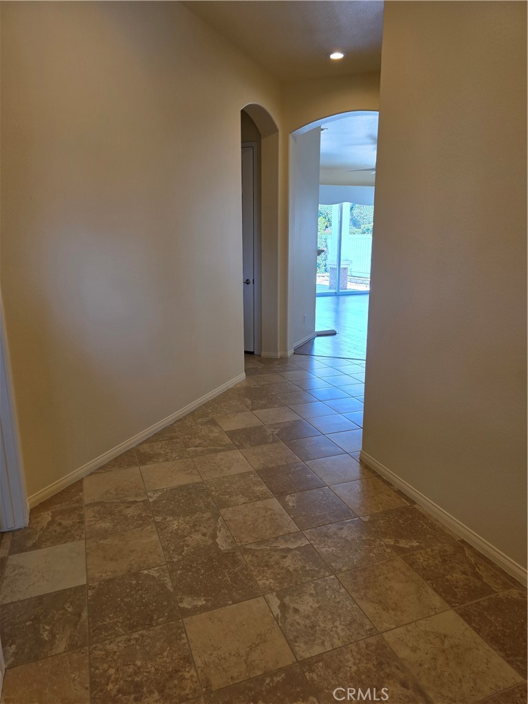 924 Brentwood Road Beaumont, CA 92223 - Photo 4 of 41 an empty room with wooden floor and windows