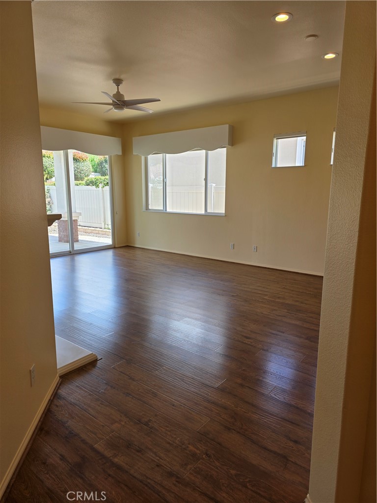 924 Brentwood Road Beaumont, CA 92223 - Photo 6 of 41 a view of an empty room with wooden floor and a window