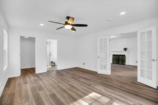 wooden floor in an empty room with a window