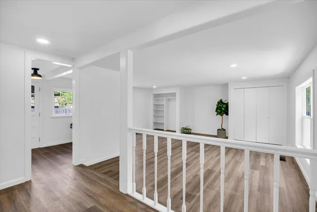 wooden floor in an empty room with a fireplace