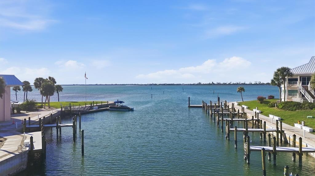 11000 Placida Road, Unit 302 Placida, FL 33946 - Photo 43 of 68 a view of a chairs and table on wooden deck with lake view