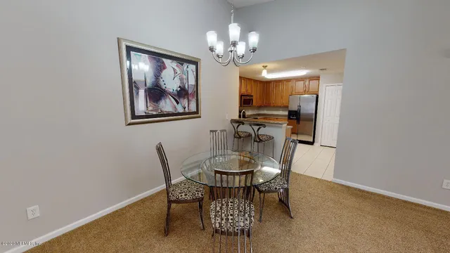 a dining room with furniture and chandelier