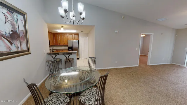 a dining room with furniture and chandelier